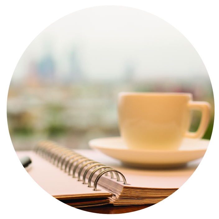 photo of a notebook and coffee cup